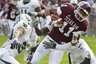Texas A&M's Terrance McCoy (11) makes a 9-yard catch as Baylor's Chance Casey, left, Jeremy Williams, bottom, and Chris Francis, right, defend during the first quarter of an NCAA college football game Saturday, Nov. 21, 2009, in College Station, Texas. (AP Photo/Dave Einsel)