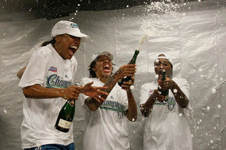 Candice Wiggins, Seimone Augustus, and Charde Houston of the Minnesota Lynx celebrate their 73-67 win over the Atlanta Dream in the WNBA Finals last night.