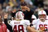 SOUTH BEND IN - SEPTEMBER 25: Head coach Jim Harbaugh of the Stanford Cardinal jumps to greet Owen Marecic #48 after Marecic intercepted a pass for a touchdown against the Notre Dame Fighting Irish at Notre Dame Stadium on September 25 2010 in South Bend Indiana. Stanford defeated Notre Dame 37-14. (Photo by Jonathan Daniel/Getty Images)